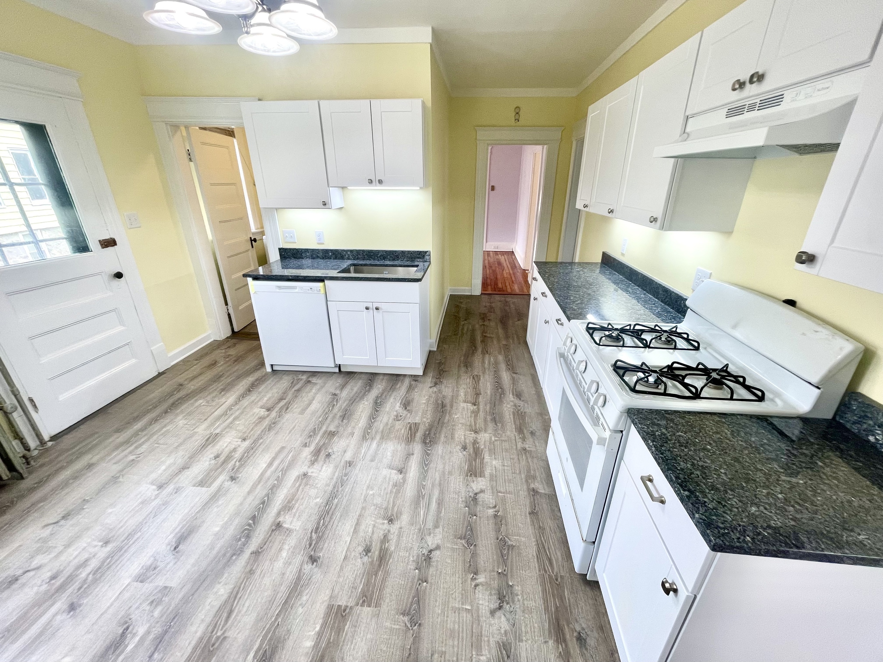 22 Upson Avenue Winchester, CT 06098 - Photo 3 of 10 a kitchen with granite countertop a sink a counter space and stainless steel appliances