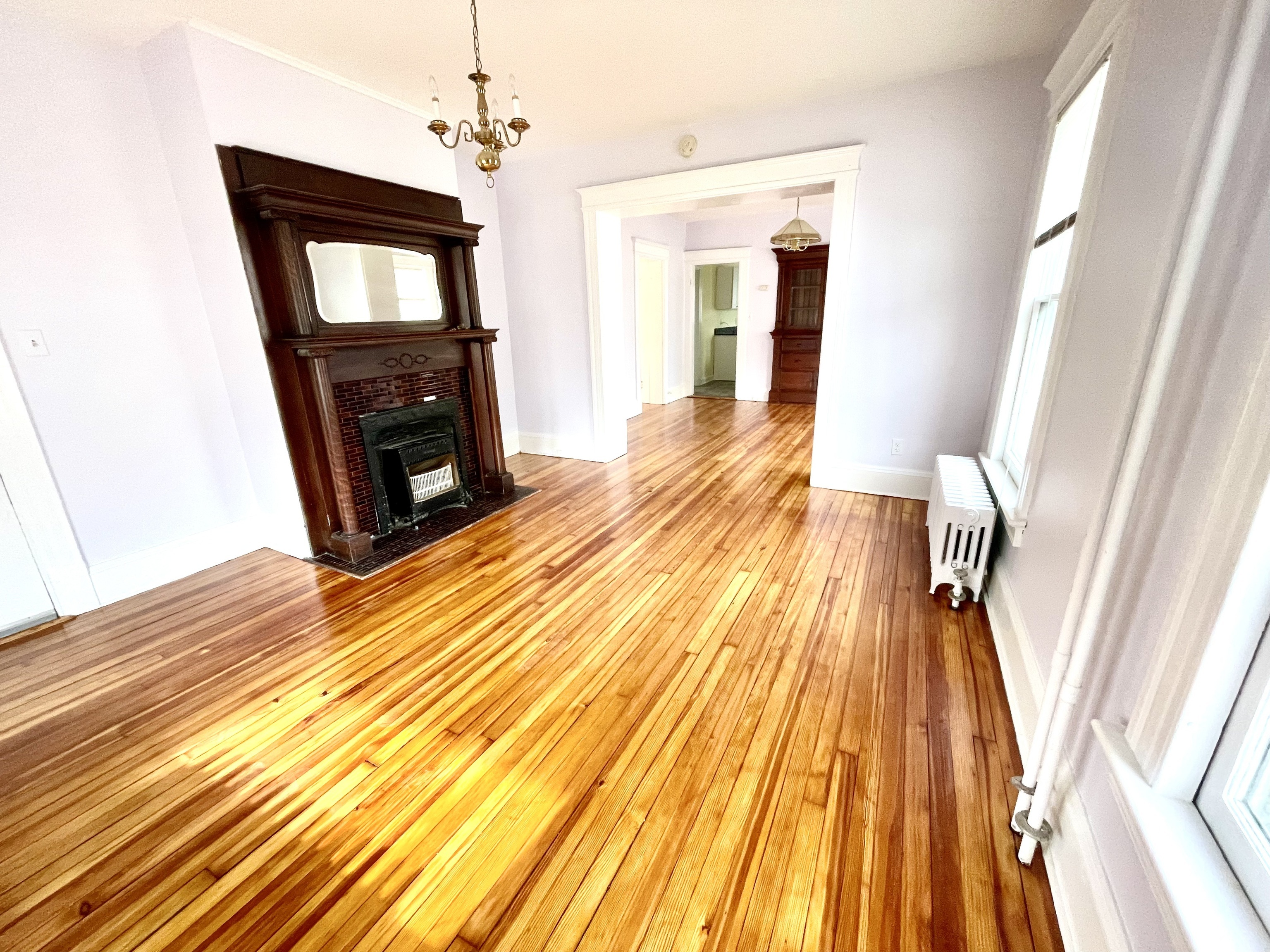 22 Upson Avenue Winchester, CT 06098 - Photo 6 of 10 a view of a livingroom with wooden floor and a fireplace