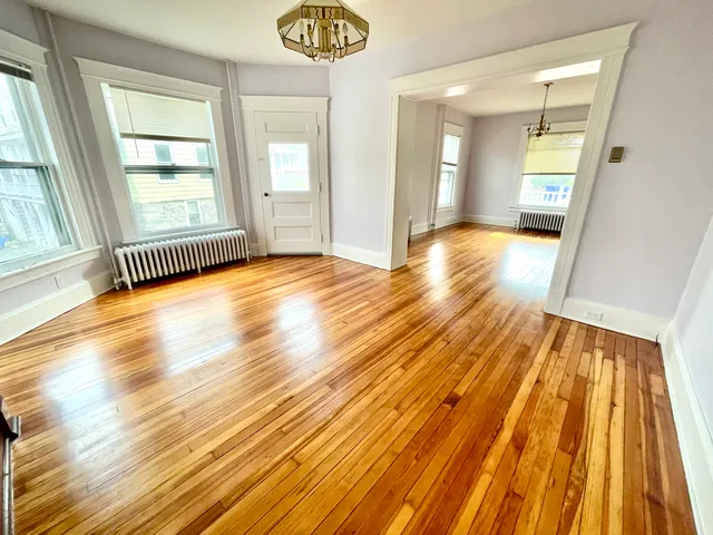 a view of a room with wooden floor and windows