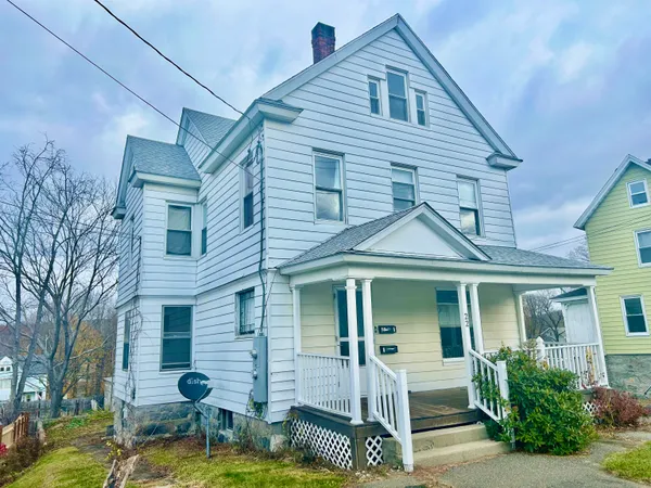 a front view of a house with garden and porch