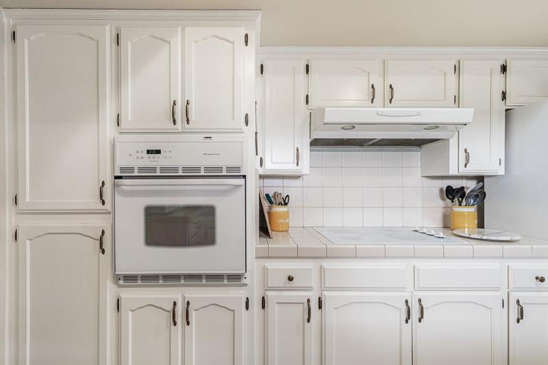 6549 North Cornelia Avenue Fresno, CA 93722 - Photo 2 of 30 a kitchen with white cabinets and white appliances