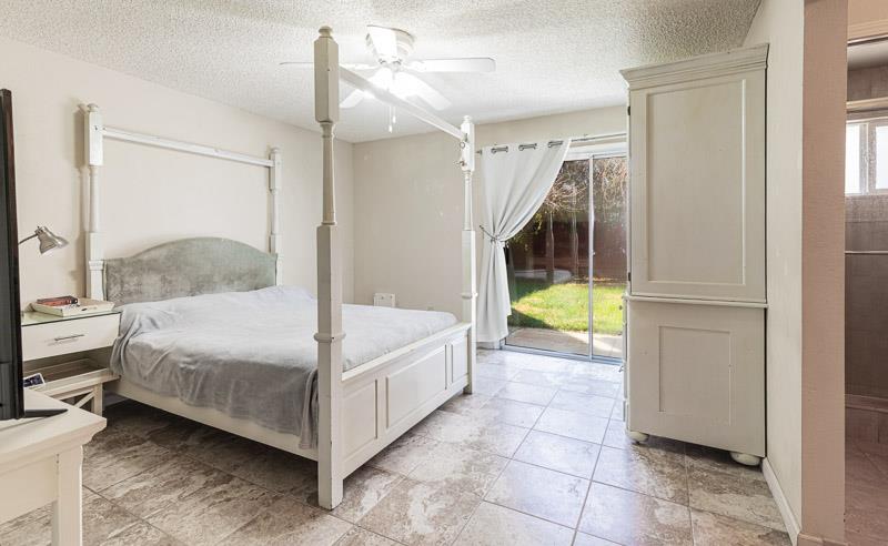 6549 North Cornelia Avenue Fresno, CA 93722 - Photo 24 of 30 a bedroom with a bed and a window
