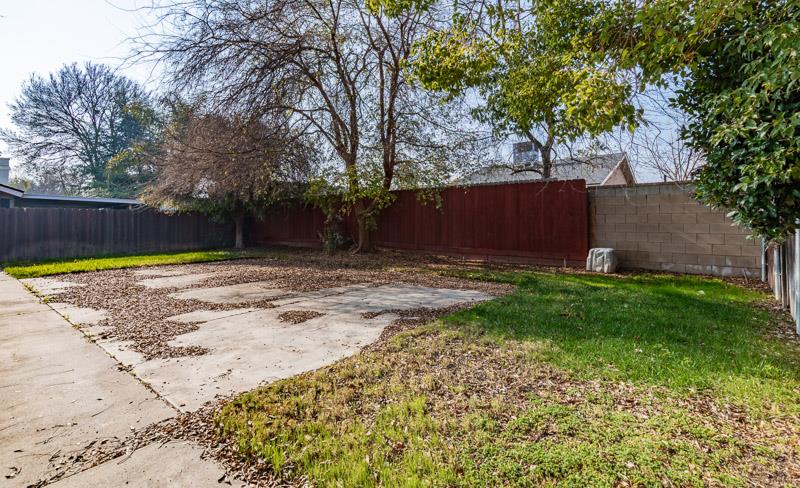 6549 North Cornelia Avenue Fresno, CA 93722 - Photo 30 of 30 a view of a backyard with large trees and a large tree