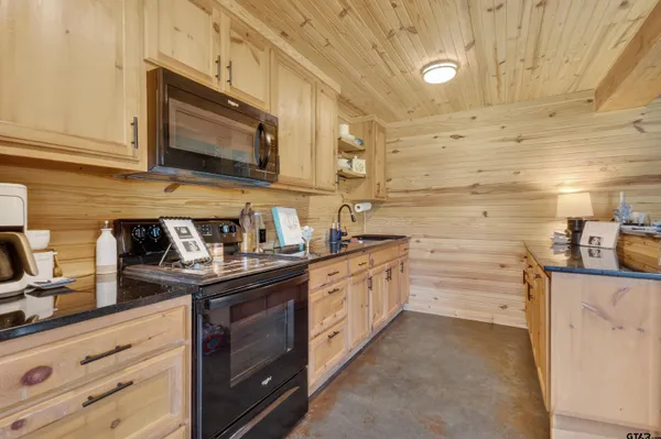 a kitchen with a refrigerator and a stove top oven