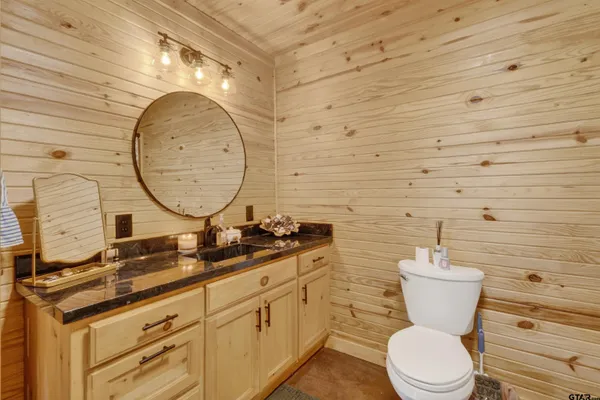 a bathroom with a sink a toilet and a mirror