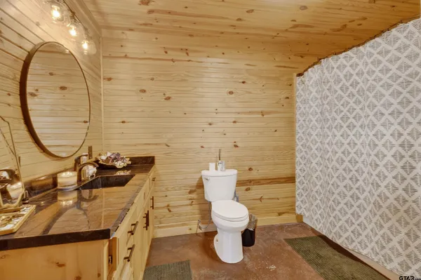 a bathroom with a shower curtain and sink