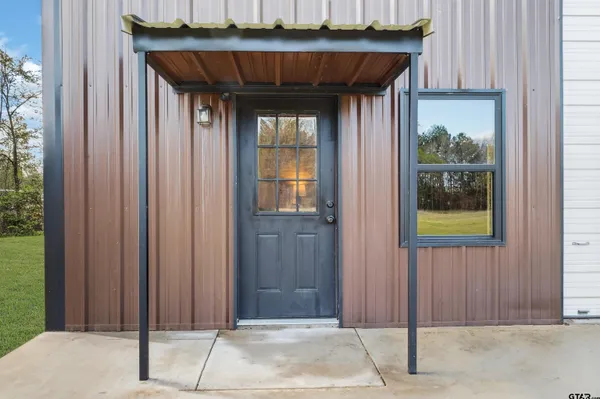 a view of a house with backyard porch and sitting area