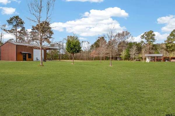a view of a backyard with a patio and a garden