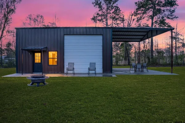 a backyard of a house with table and chairs