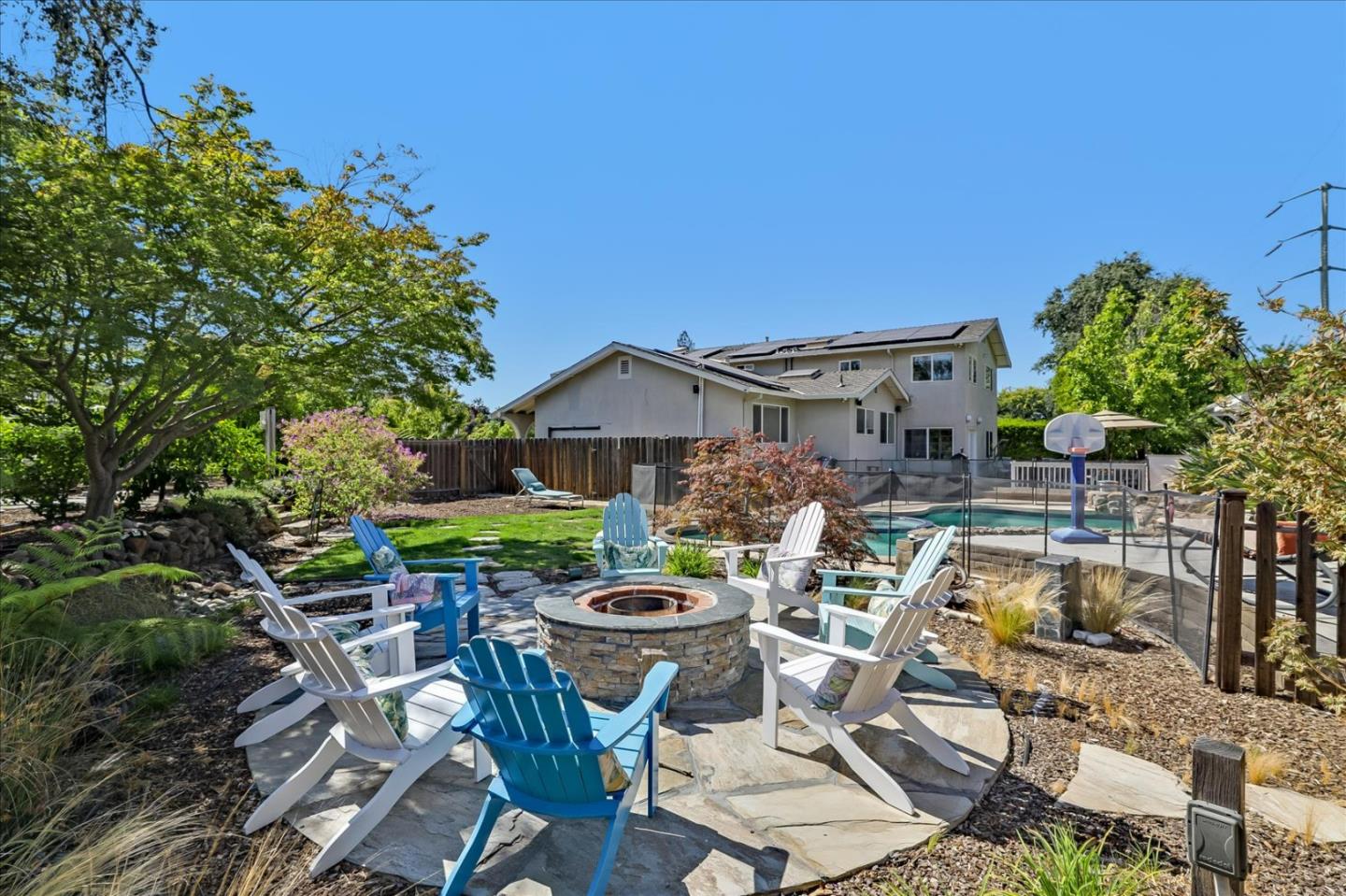 a view of a patio with table and chairs potted plants and large tree