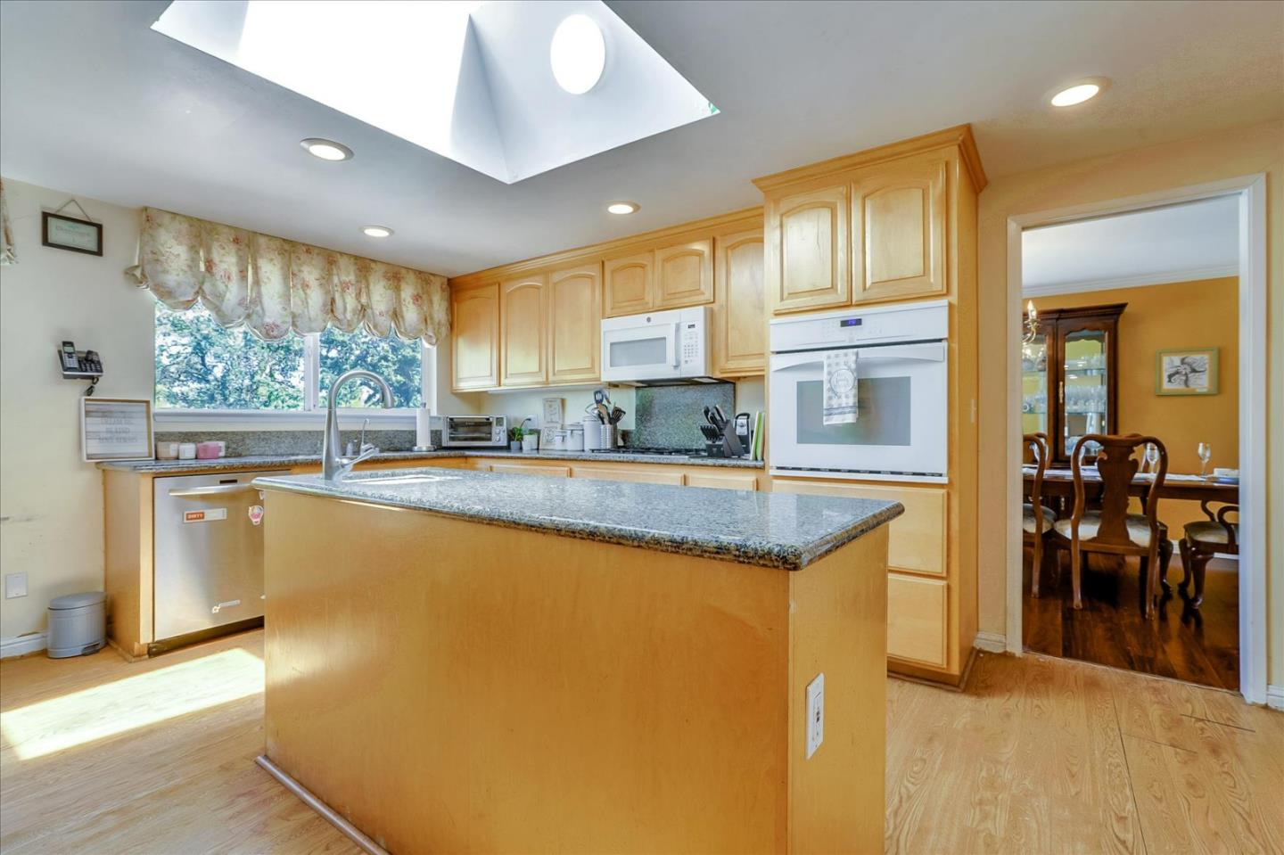 7166 Brooktree Way San Jose, CA 95120 - Photo 14 of 48 a kitchen with stainless steel appliances granite countertop a sink a stove and a refrigerator