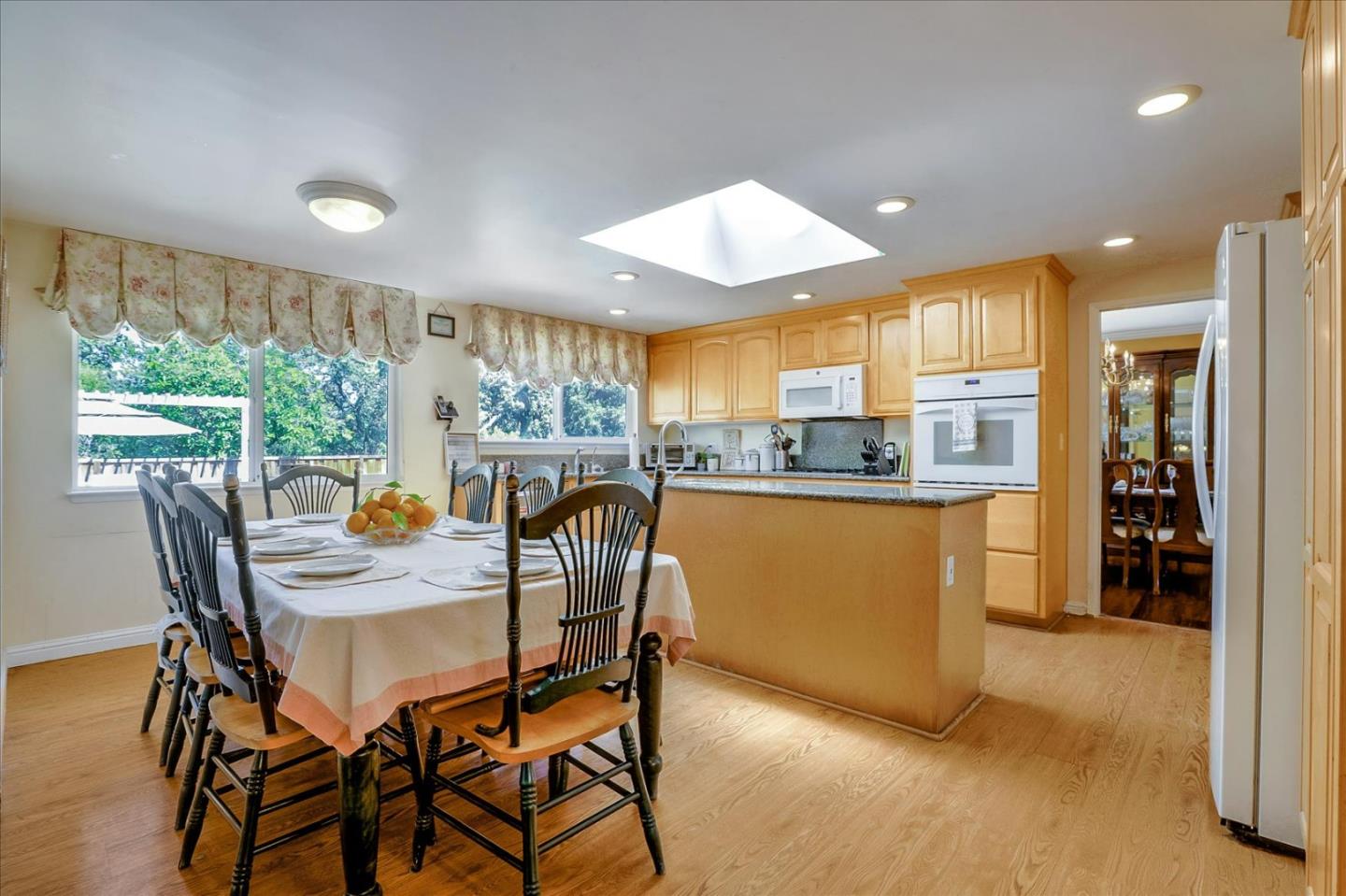 7166 Brooktree Way San Jose, CA 95120 - Photo 15 of 48 a kitchen with stainless steel appliances granite countertop wooden floor a refrigerator and a sink