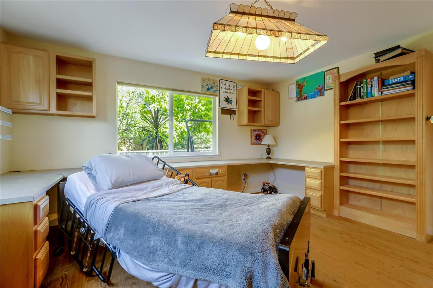 7166 Brooktree Way San Jose, CA 95120 - Photo 17 of 48 a bedroom with a bed and a chandelier