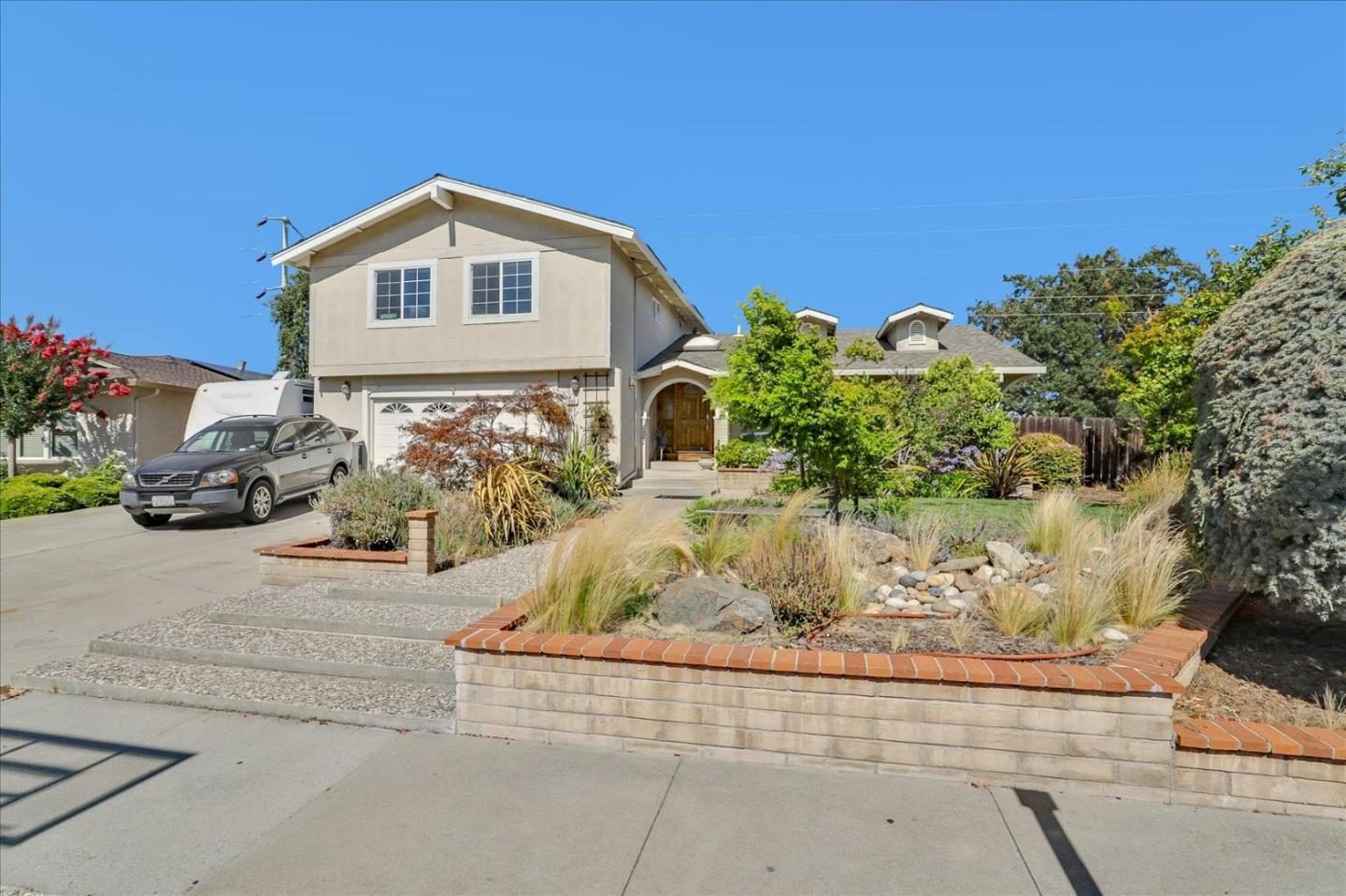 7166 Brooktree Way San Jose, CA 95120 - Photo 2 of 48 a front view of a house with a yard