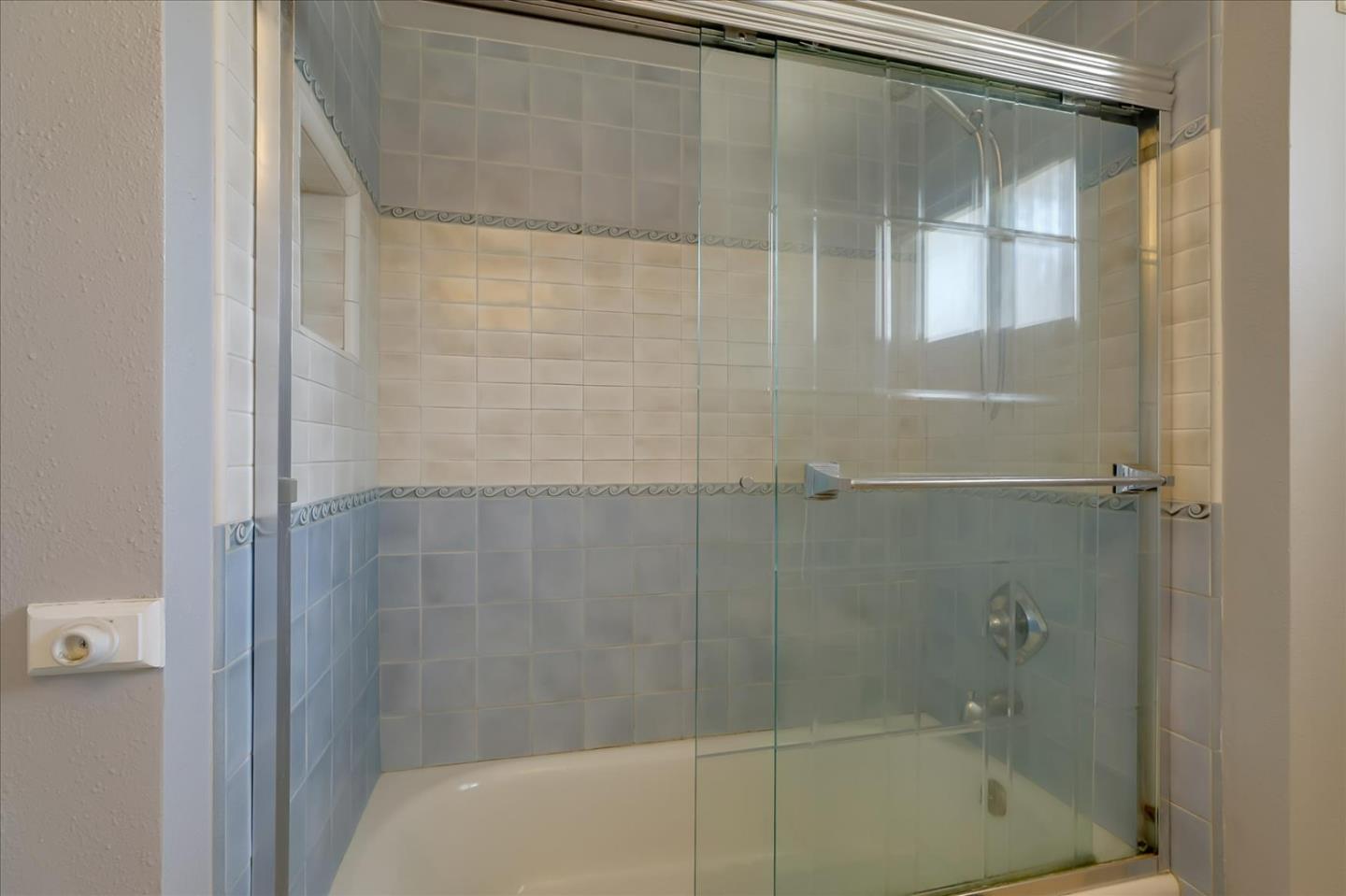 7166 Brooktree Way San Jose, CA 95120 - Photo 26 of 48 a bathroom with a glass shower door