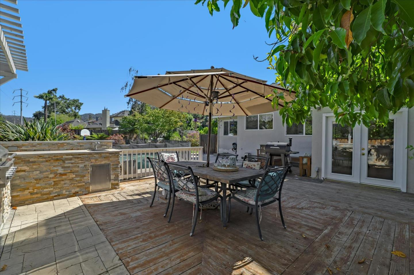 7166 Brooktree Way San Jose, CA 95120 - Photo 32 of 48 a view of a roof deck with table and chairs under an umbrella
