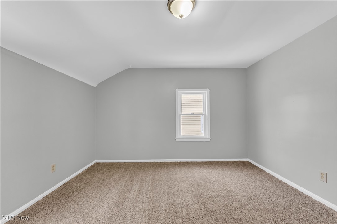 4693 Liberty Road South Euclid, OH 44121 - Photo 22 of 33 Empty room featuring light carpet and vaulted ceiling