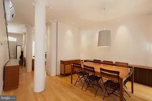 a view of a room with furniture and wooden floor