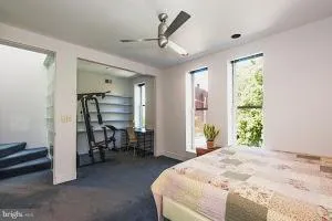 a bed room with a bed and a chair