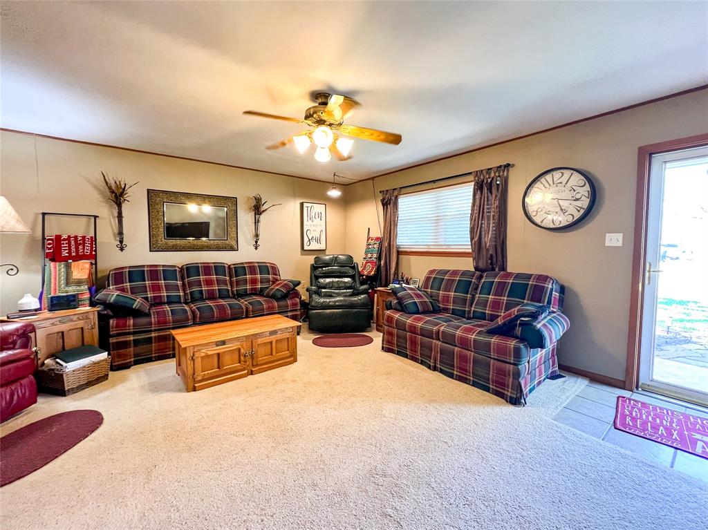 1009 North 7th Street Haskell, TX 79521 - Photo 4 of 26 a living room with furniture a flat screen tv and a large window