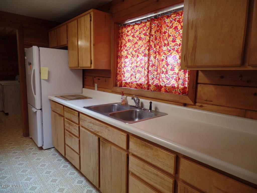 1124 North 650 Street Snowflake, AZ 85937 - Photo 11 of 35 a kitchen with stainless steel appliances a sink cabinets and a refrigerator