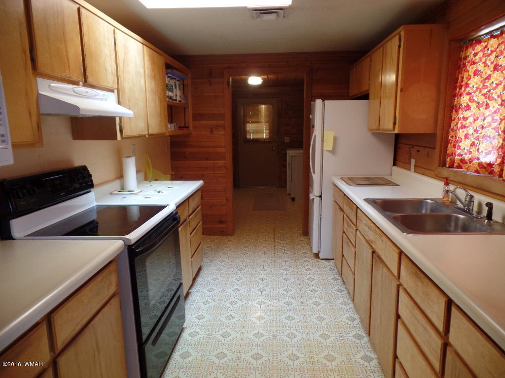 1124 North 650 Street Snowflake, AZ 85937 - Photo 12 of 35 a kitchen that has a sink and a stove in it