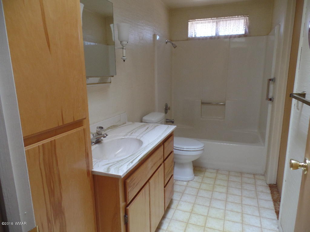 1124 North 650 Street Snowflake, AZ 85937 - Photo 14 of 35 a bathroom with a granite countertop sink toilet and shower