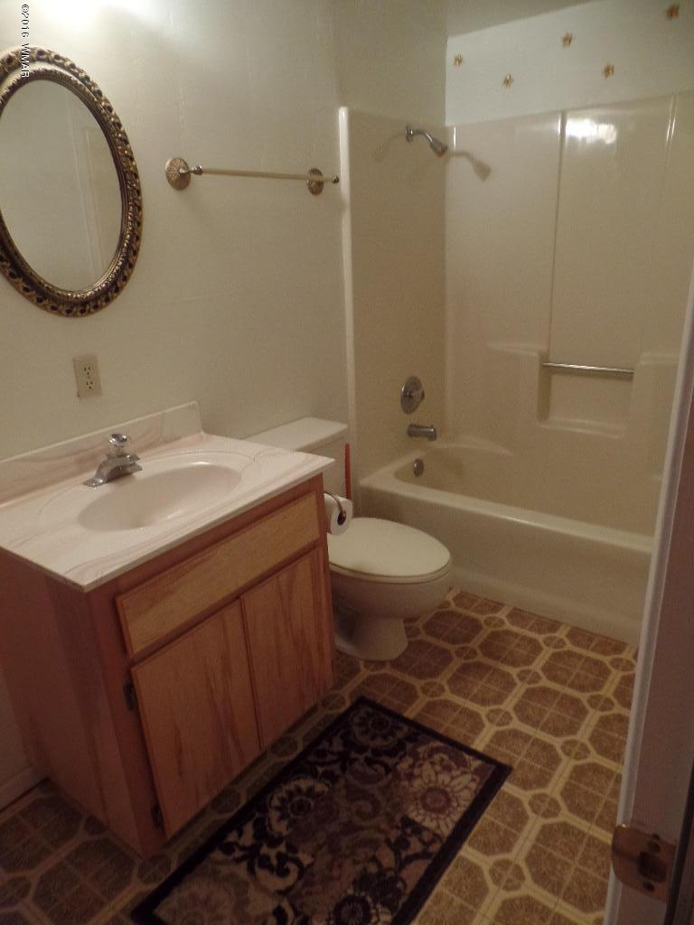 1124 North 650 Street Snowflake, AZ 85937 - Photo 22 of 35 a bathroom with a sink toilet a mirror and shower