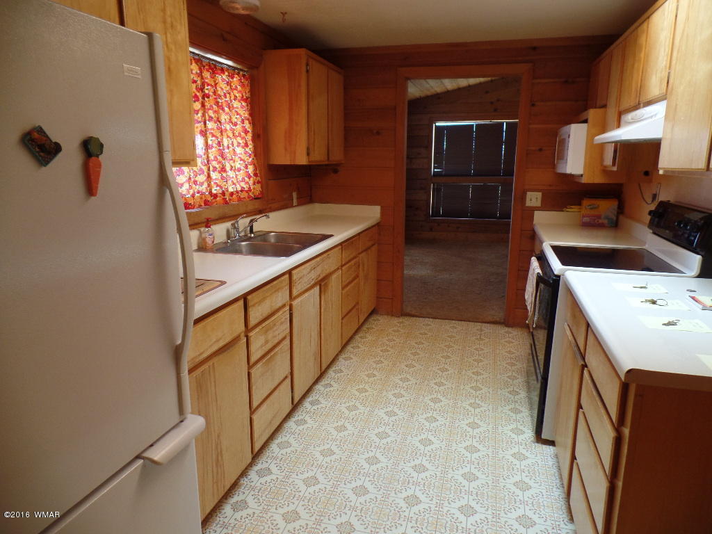 1124 North 650 Street Snowflake, AZ 85937 - Photo 9 of 35 a kitchen with granite countertop a sink a stove and refrigerator