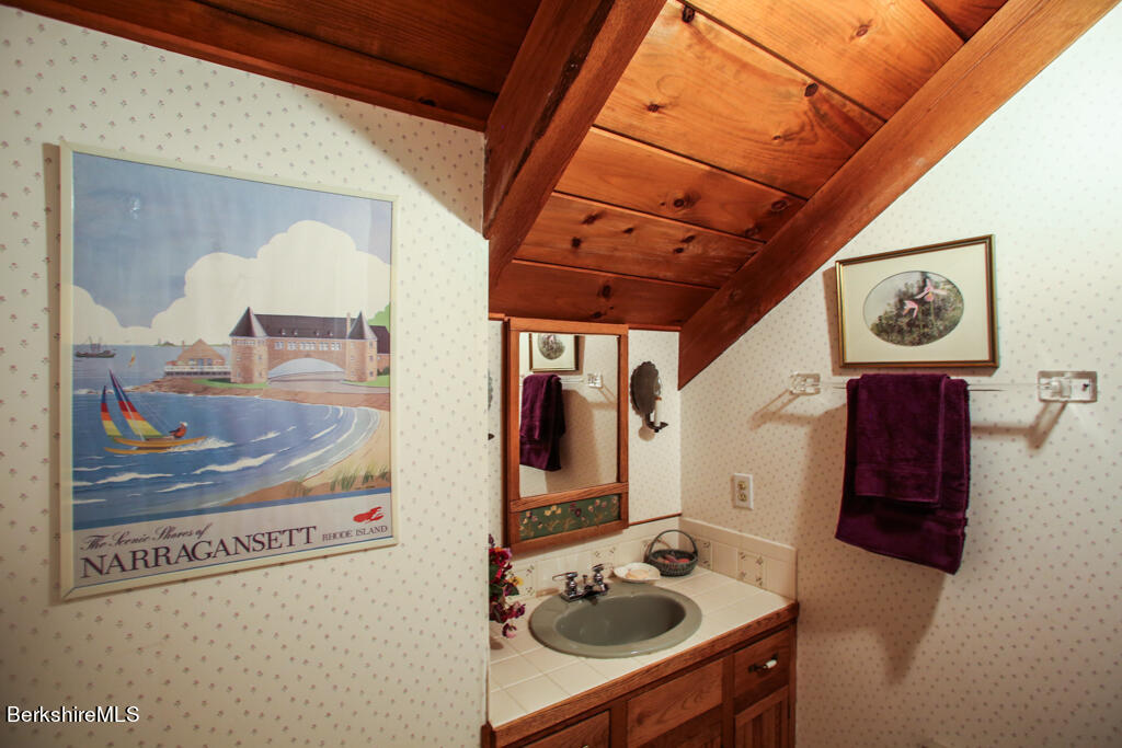 544 Tunnel Road Rowe, MA 01367 - Photo 26 of 32 a bathroom with a sink and mirror with bathtub