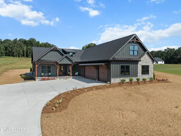 a front view of a house with yard and parking space