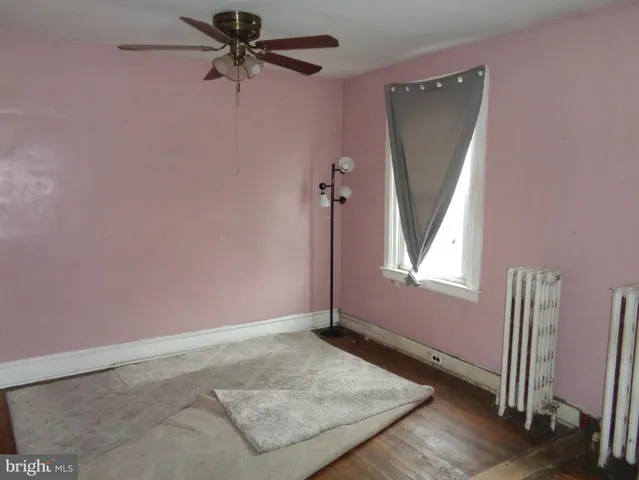 a view of a room with a ceiling fan