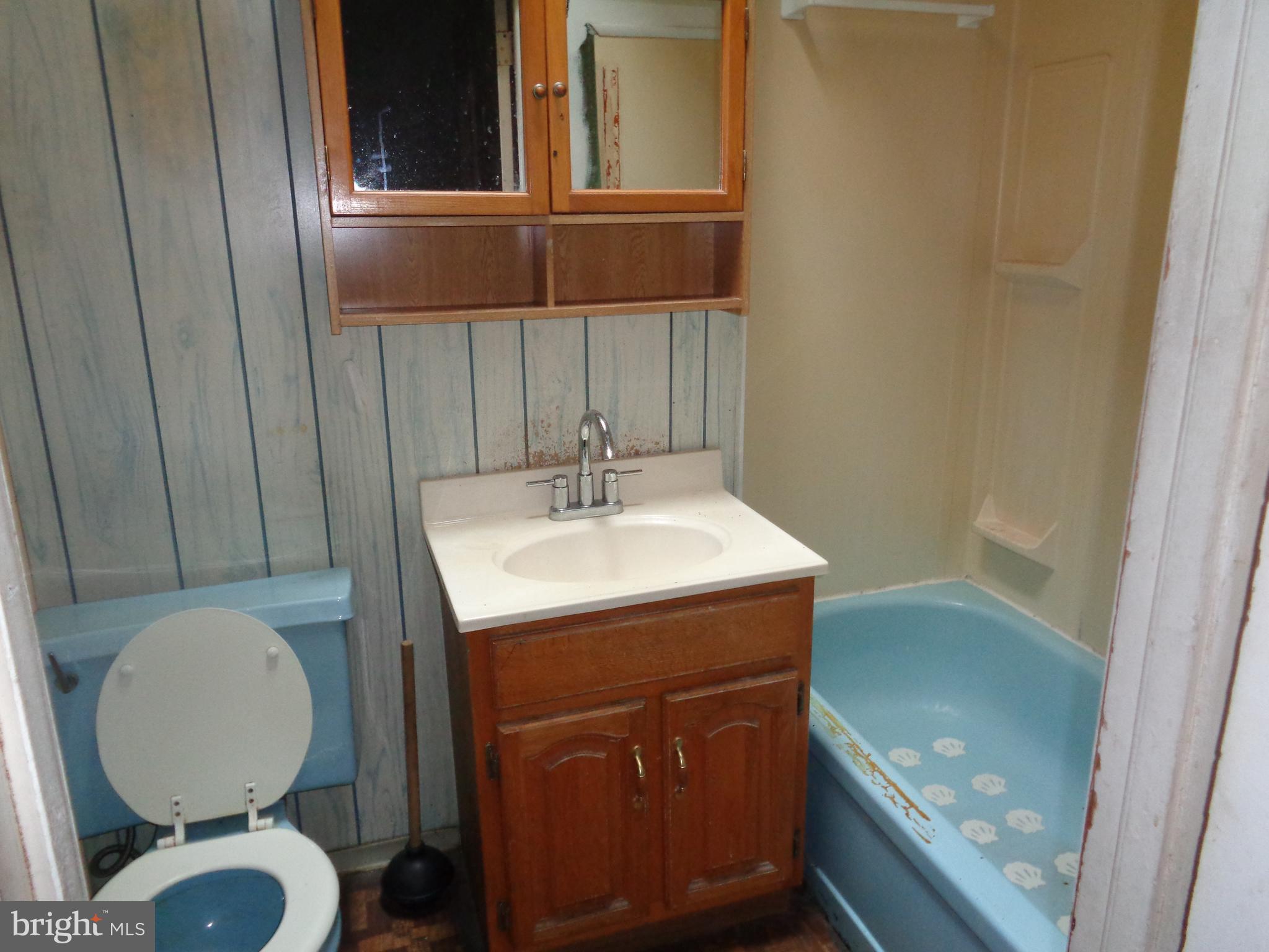 4636 Kraydor Street Philadelphia, PA 19136 - Photo 10 of 13 a bathroom with a sink a toilet and a mirror