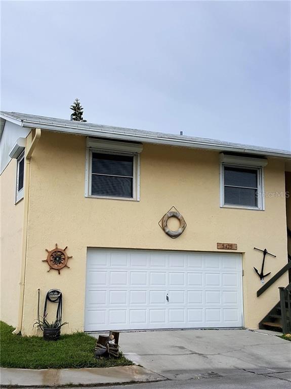 5429 Merit Drive, Unit 5429 New Port Richey, FL 34652 - Photo 1 of 1 a front view of a house with garage