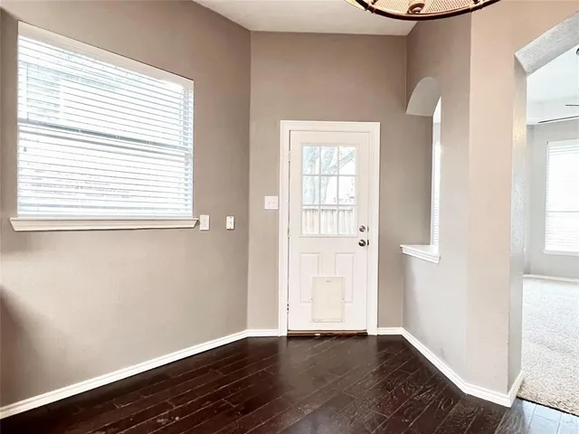 a kitchen with stainless steel appliances granite countertop a sink a microwave cabinets and a wooden floor