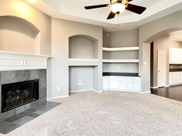 a view of a livingroom with a fireplace and a window
