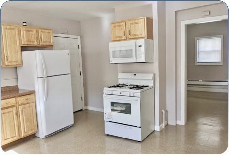 69 Burrell Street Boston, MA 02119 - Photo 8 of 9 a white refrigerator freezer and a stove sitting inside of a kitchen