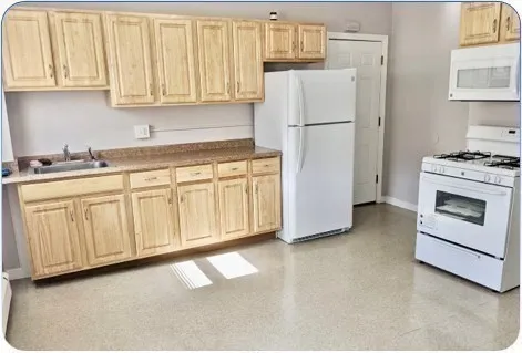 a white refrigerator freezer sitting in a kitchen