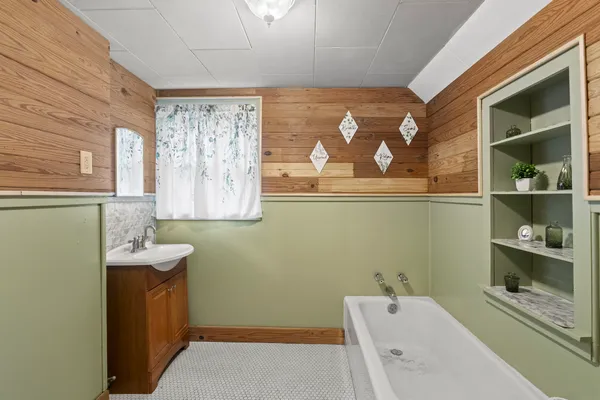 a bathroom with a sink a toilet and a tub