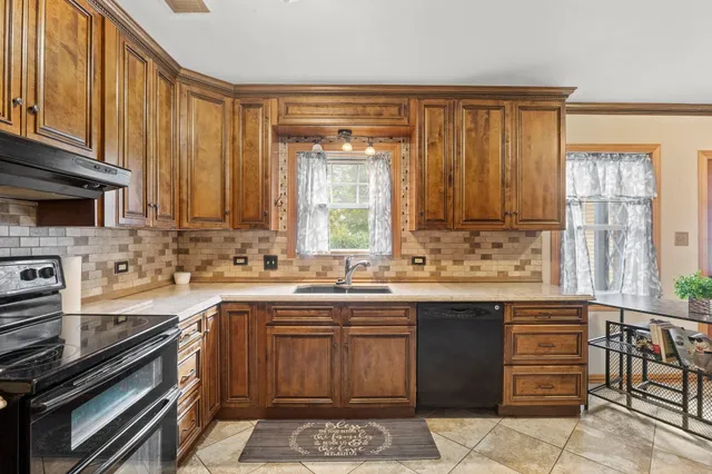 a kitchen with a sink stove and cabinets