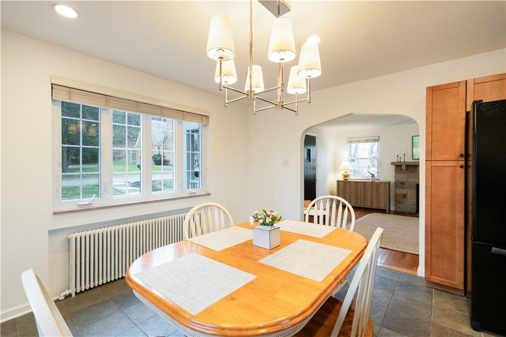 111 Sycamore Drive Pittsburgh, PA 15237 - Photo 14 of 24 a dining room with wooden floor a chandelier a wooden table and chairs