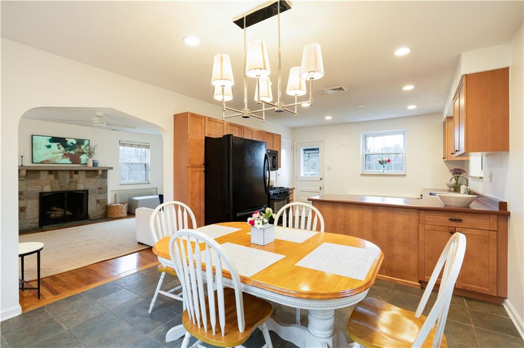 111 Sycamore Drive Pittsburgh, PA 15237 - Photo 9 of 24 a kitchen with a dining table chairs and fireplace