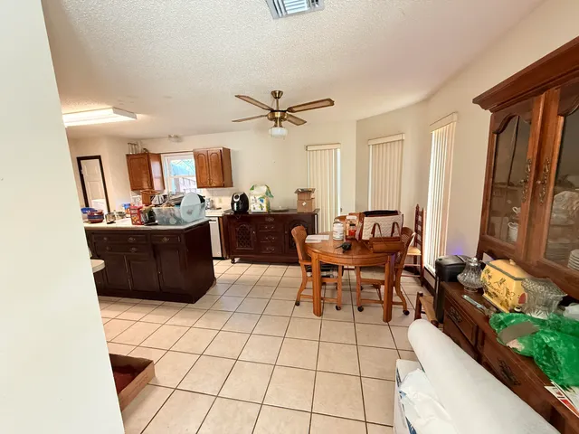 a living room with furniture a flat screen tv and a stove