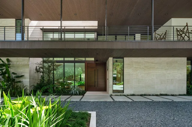 a view of a house with a large tree and a yard