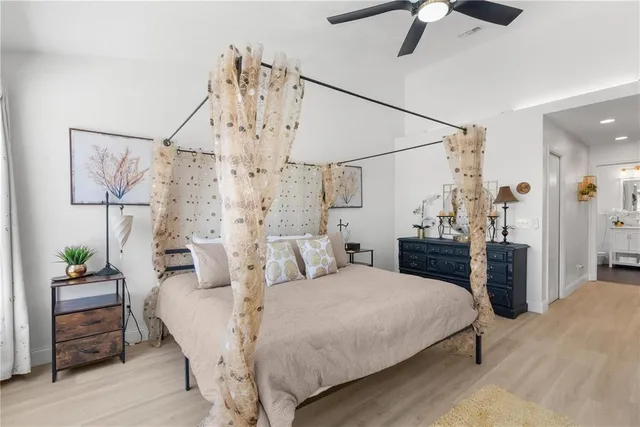 a bedroom with a bed and a chandelier