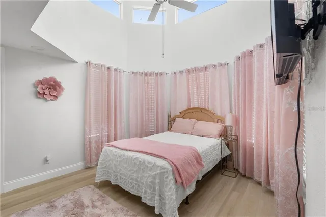 a bedroom with a bed and a chandelier