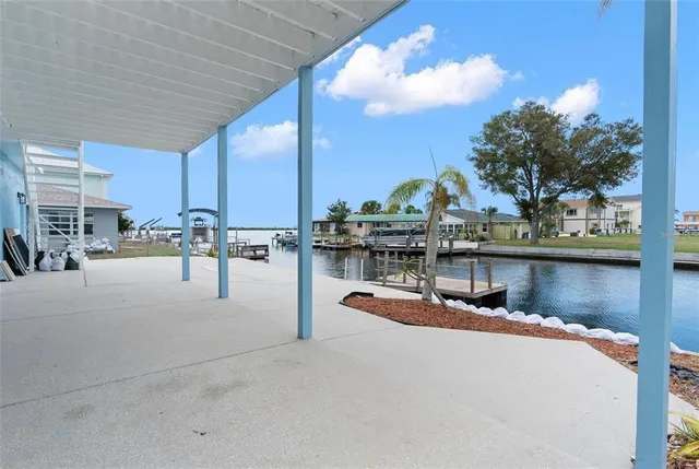 a view of a swimming pool with outdoor seating