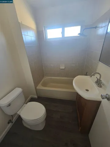a bathroom with a toilet a sink and bathtub