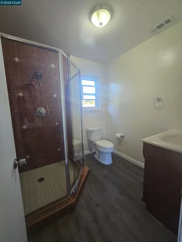 a bathroom with a toilet and a shower