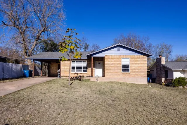 a view of a house with a yard and sitting area